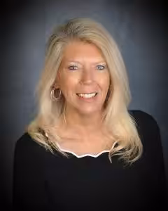 Attorney Deb Zeyher consulting with a client about debt defense strategies in a Florida law office