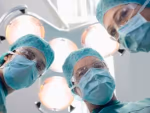 Medical Debt is Mounting - Ziegler Diamond Law surgeons looking down at patient from patient's perspective