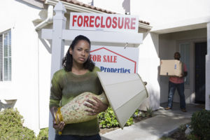 couple moving out of foreclosed house