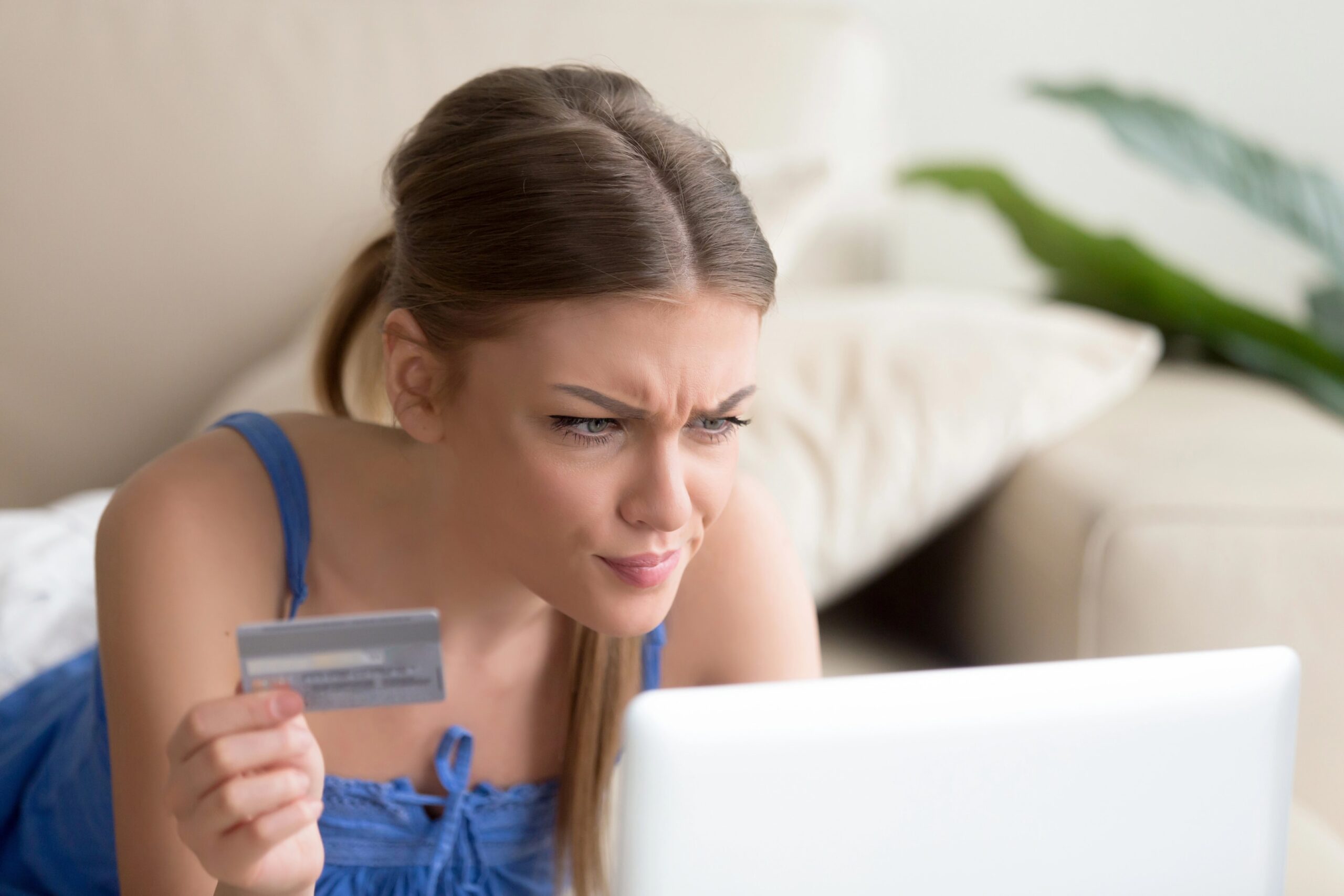 A person looking confused while reviewing their credit report, highlighting the issue of inaccurate credit reporting.