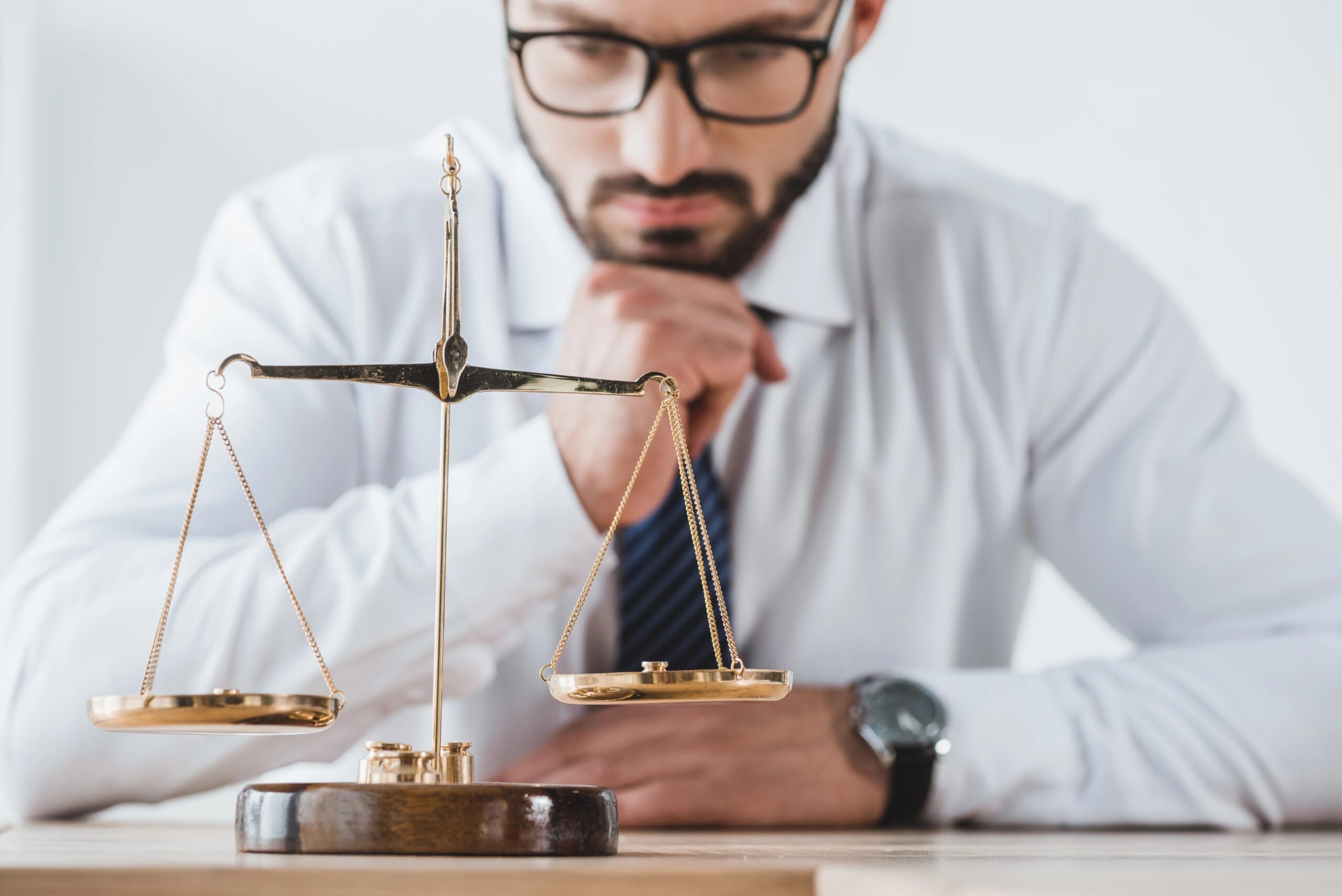 Picture illustrating balance with lawyer looking at scale