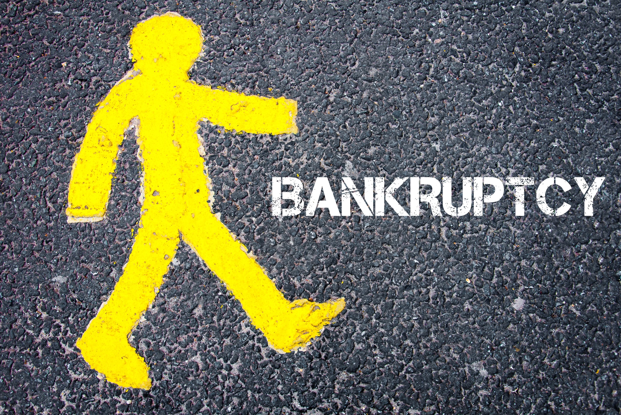 Yellow pedestrian figure walking towards BANKRUPTCY